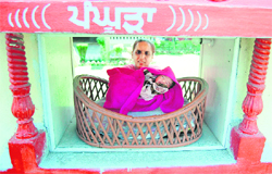 A worker with the newborn baby abandoned in the Pangura at the Red Cross Bhavan in Amritsar on Friday