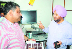 Civil Surgeon Avtar Singh Jarewal (right) and Atul Kapoor owner of the ultrasound centre at the time of the sealing of machines in Amritsar on Friday