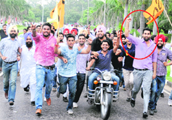 The newly elected president of the PU Student Council, Pushpinder Sharma (encircled), departed from the traditional practice of the new president riding a jeep in a victory procession every year to run with his supporters on the campus on Friday