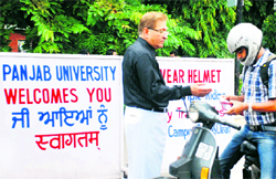 PU VC Prof RC Sobti checks an identity card of a student at the main gate on Friday