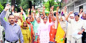 Members of the families of ex-servicemen hold a demonstration in front of the District Magistrate office in Dehradun on Friday.