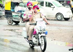 Who will police us? Flouting traffic norms, a policeman talks on his mobile phone while riding a motorcycle near Jyoti Chowk in Jalandhar on Friday