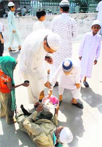 A beggar seeks alms outside Khatikan Talab Mosque in Jammu. 