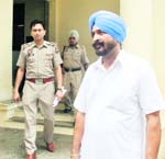 Nabha SHO GS Sikand and complainant Gurnek Singh (in white kurta pyjama) come out of the office of PPS, Nabha, on Friday. 