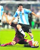 Argentinas Lionel Messi takes the ball from Venezuelas Ternando Amorebita during the FIFA Freindly International match in Kolkata on Friday.