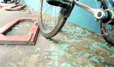 Shattered pieces of glass and broken window frames outside the house at Palsora in Chandigarh on Saturday.
