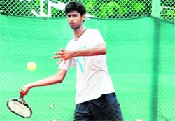 A player in action during a tennis match at Panchkula on Saturday.