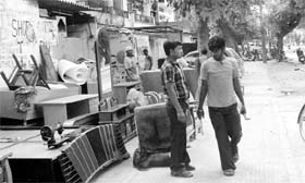 Residents encroach upon a roadside, leading to traffic jams at Phase IV in Mohali.