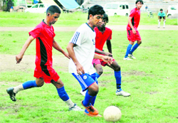 A match between Adhoiwala XI (in red) and Akranta Club (in white) in the Lala Nemi Dass Football Tournament in progress in Dehradun on Saturday