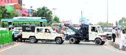 Traffic police park their vehicles to divert the traffic after members of the Unemployed Linemen Union, Punjab, blocked the road in Amritsar