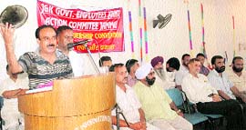 A speaker addresses a one-day convention of the Government Employees Joint Action Committee in Jammu on Saturday.