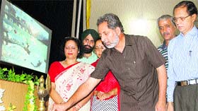 Minister for Higher Education, Labour and Employment Abdul Gani Malik lights a lamp at Government College for Women, Parade, in Jammu on Saturday.