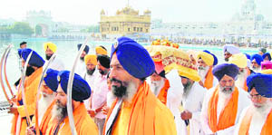 Sikh devotees participate in a nagar kirtan to mark the 112th birth anniversary of Sikh warrior Shaheed Baba Jiwan Singh at the Golden Temple on Saturday. 