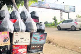 Helmets without ISI certification being sold on a roadside in Chandigarh