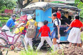 Schoolchildren push a three-wheeler that broke down in Sector 40, Chandigarh. The kids were heading home
