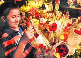 A boy selects a rose stick for his teacher on the eve of Teacher’s Day in Chandigarh on Sunday