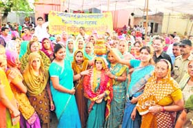 Enthusiastic people perform the kuan poojan ceremony to celebrate the birth of a girl child at Meham in Rohtak district on Saturday.