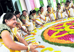 Women prepare a rangoli to celebrate Onam in Ludhiana on Sunday