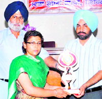 Jatinder Kaur, a teacher, being honoured at a function in Fatehgarh Sahib recently