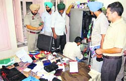A police team takes fingerprints at the house where burglars decamped with jewellery and cash in Amritsar 