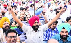A member of the Punjab Federation of University and College Teachers Organisations raises slogans against the Punjab government in Chandigarh on Monday. 