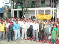 Civic body staff members stage a demonstration in 