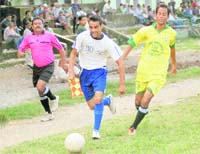A player of Akranta Club (in white) is lchased by a player of Gypsy Young (in yellow) in the Lala Nemi Dass Memorial District Football League played in Dehradun on Monday.
