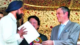 Chief Minister Omar Abdullah gives away an award to a teacher at a function in Srinagar on Monday.