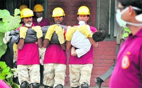 Members of the National Disaster Response Force take part in a mock drill at a Government Senior Secondary on the PAU campus in Ludhiana