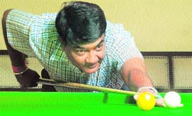 Mukesh Chopra aims to pot the yellow ball during a match of the Chandigarh Club Amateur Snooker Tournament in Chandigarh on Tuesday.