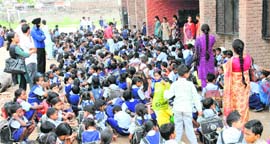 With overcrowded classrooms, courtyard and corridors, those in the evening shift arriving early are forced to sit in the ground, waiting for their turn to get some space.
