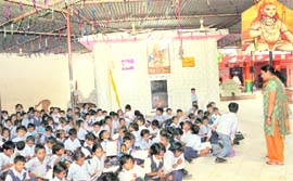 With a block under construction and the other overcrowded, over 200 students of class I study English on the temple premises at the Government High School in Hallo Majra.