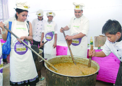 Chefs from a five-star hotel prepare baingan ka bharta at Delli Haat in New Delhi on Tuesday