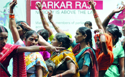 Activists of Asha shout slogans during their protest against the UPA government 