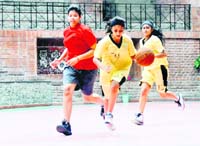 A player of Welham Girls School with the ball during a match in the Dehradun District Basketball Championship against Summer Valley School in Dehradun on Tuesday.