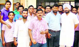 INTUC activists, led by state president Hardeep Bawa, agitate in Baddi on Tuesday.