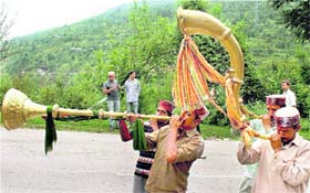 Folk artistes play traditional instruments during a ceremony believed to protect the state from natural calamities in Kullu