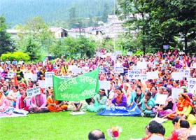 Women of the Upper Kullu Valley show placards to register their protest against the setting up of the power project in Manali