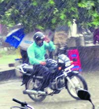 A motorcyclist tries to steer his way through the downpour in Jalandhar on Tuesday.