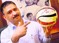 Rajesh Kharbanda, the Managing Director of Freewill Sports shows Nivia Simbolo footballs with autographs of Lionel Messi. 