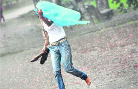 A girl tries to protect herself from the sudden shower in Ludhiana