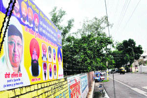 In violation of the model code of conduct, a hoarding of SGPC president Avtar Singh Makkar and Rajinder Kaur, both candidates for the SGPC election, is put up on the wall of SCD Government College in Ludhiana. 