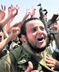 Rebel fighters wave the victory sign after a meeting of Warfalla tribe elders with NTC representative