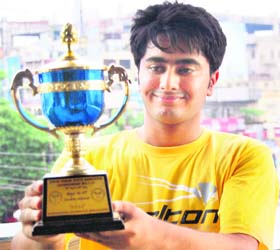 Rahul Soni shows the trophy won in the doubles of the Open State Junior Badminton Championship