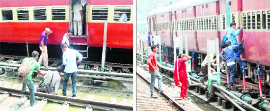 Risking their lives, passengers cross the railway track to board a train in Amritsar