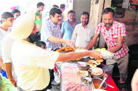 The team questions traders selling unhygienic food items in the shops located around the Golden Temple complex in Amritsar on Wednesday