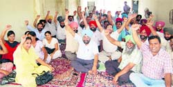 Members of the Punjab State Warehousing Corporation Field Employees and Class IV Employees Union protest against the state government in Amritsar