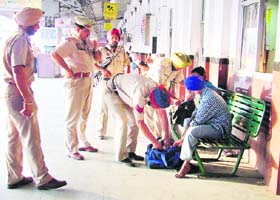 Cops check baggage of passengers at the Ludhiana railway station