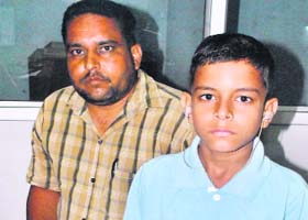 Class I student Gurinder Singh with his father in Patiala on Wednesday