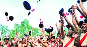 Newly recruited constables of the Chandigarh Police toss their caps after the passing-out parade in Chandigarh on Thursday.